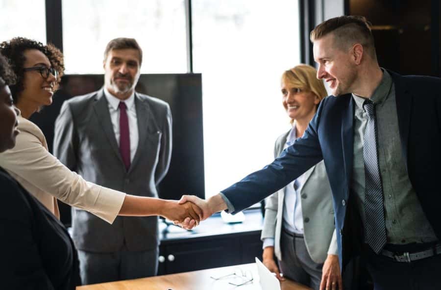 woman shaking a man's hand at job interview