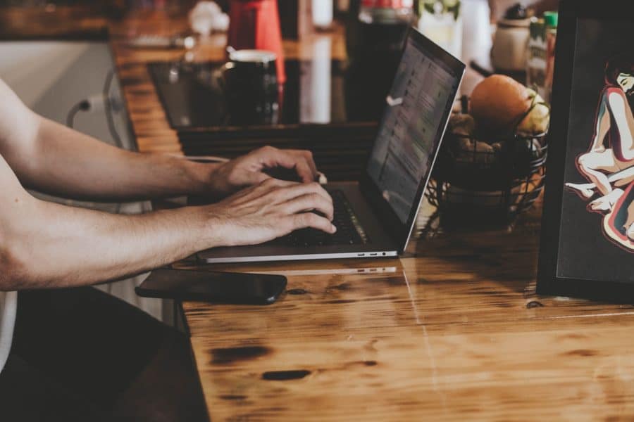 man typing on computer