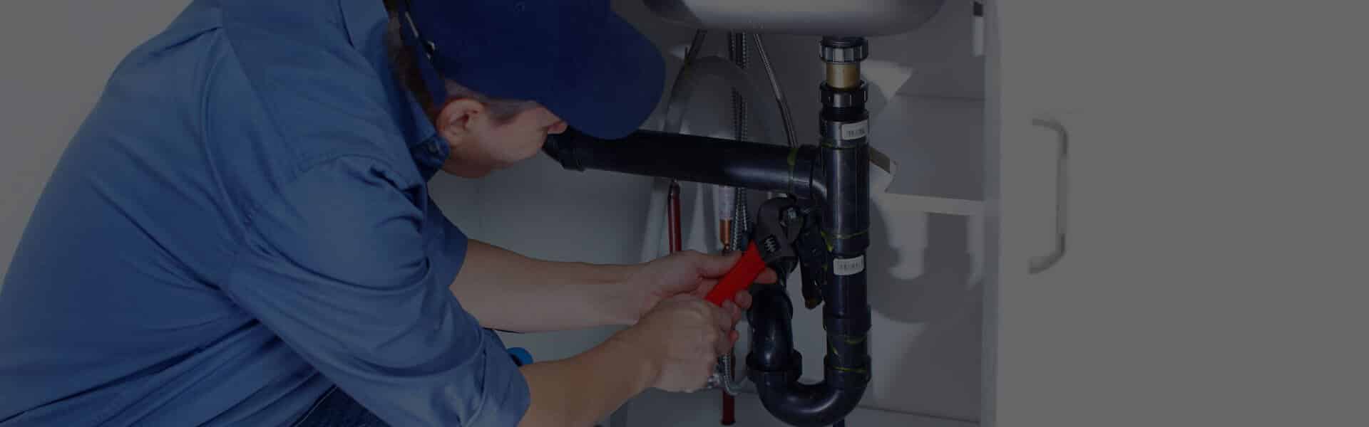 plumber working on sink drain