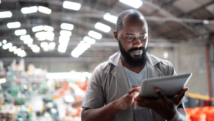 A man with a beard works on his tablet